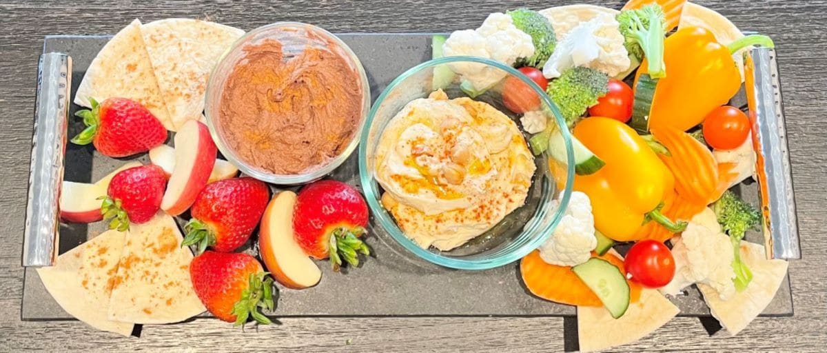 Sweet & savory hummus with various dipping options.  Vegetables and pita bread for savory hummus and fruit and cinnamon pita chips for sweet hummus.