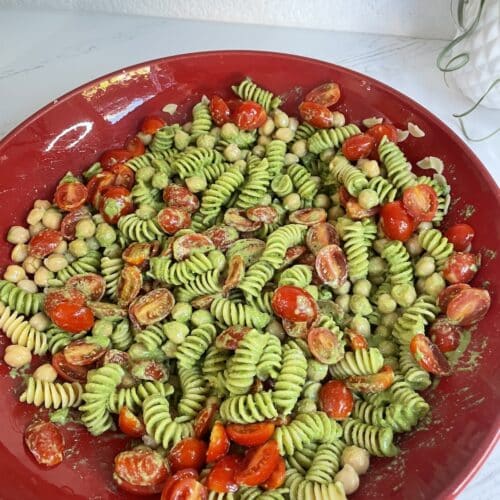 pesto pasta in a large red dish