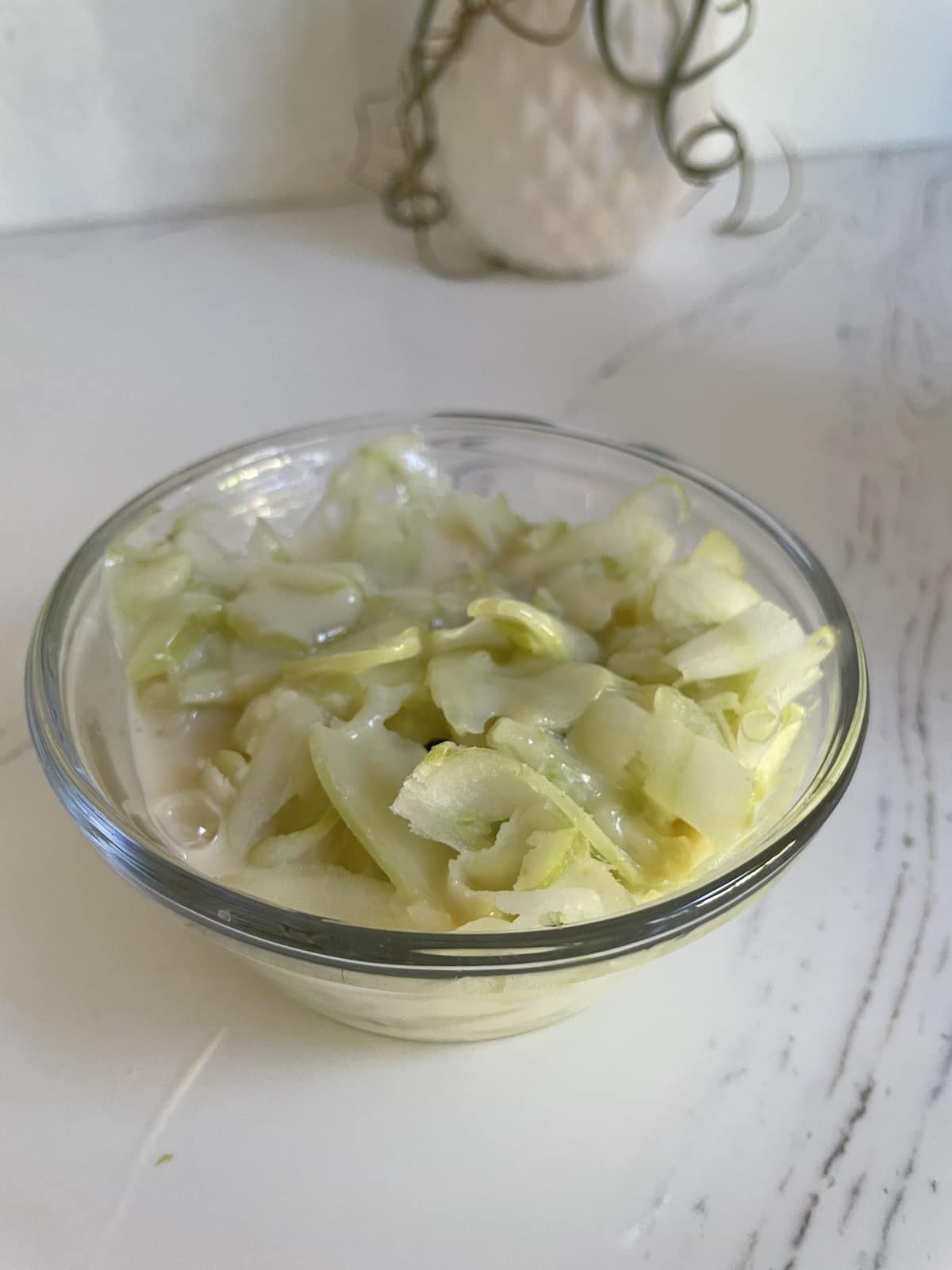 frozen shaved green grapes in a clear dish with vanilla soy milk. Finished shaved ice.