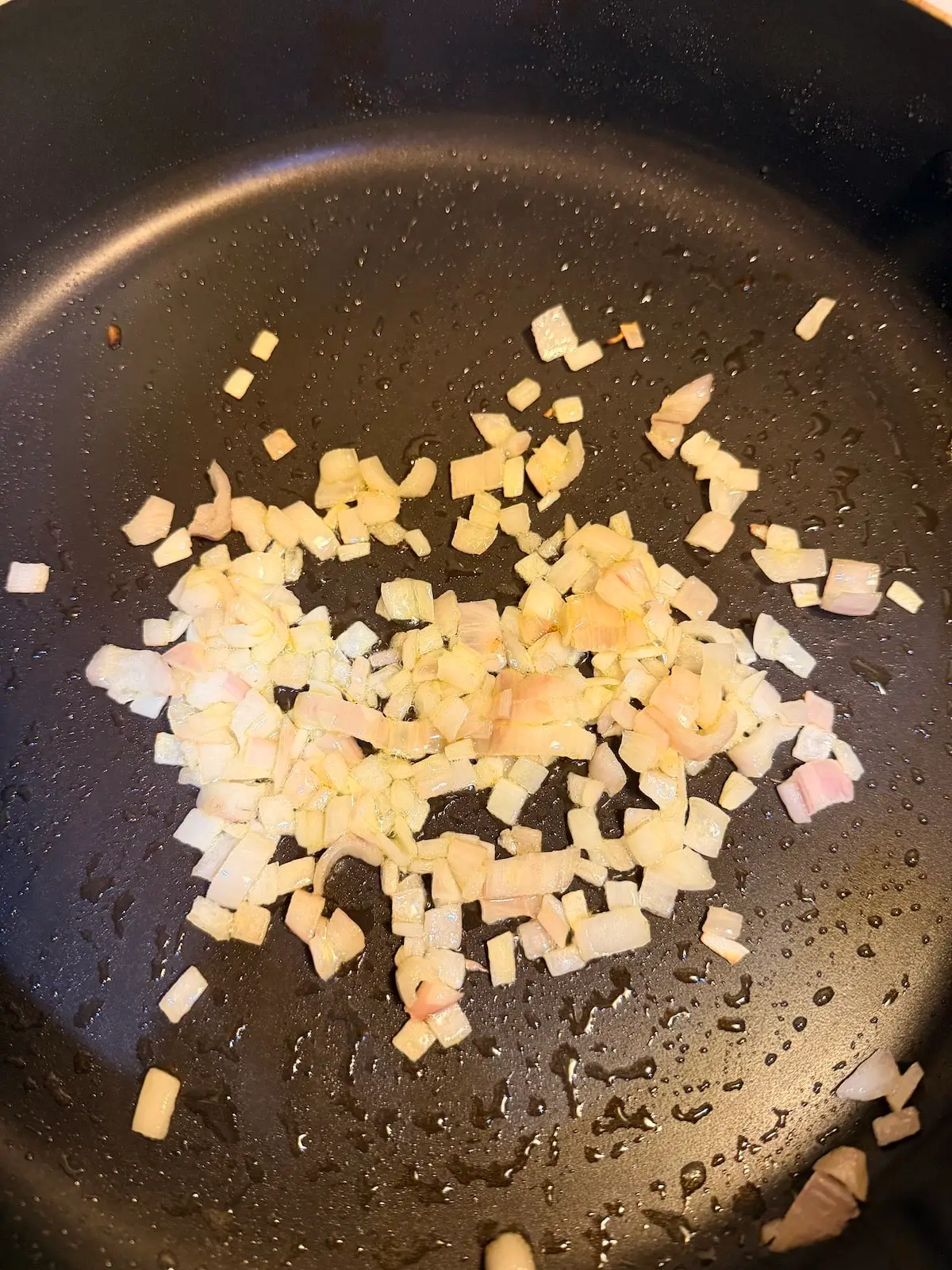 cooked diced shallots in a skillet