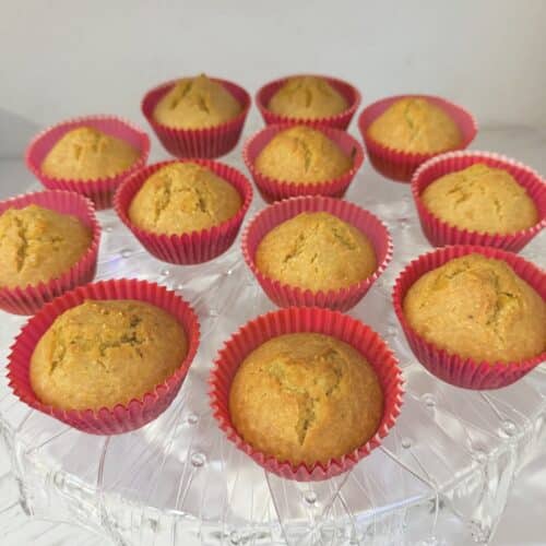 buttermilk cornbread muffins in pink muffin cups atop a crytal platter.